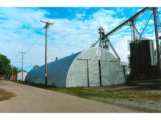 <b>TRACT #1 - GRAIN ELEVATOR</b>  (<b>SOLD - 9/9/16 $110,000</b>)
Note:  The grain bins, drier and legs are on R.R. leased property.  Mr. Voreis stated that lease payment is $900/year.

<b>Improvements - Grain Bins, Drier & Legs:</b>
1994     90,000 bu. bin with air tubes
1994     15,000 bu. hopper bin
               7,000 bu. bin
             42,000 bu. bin with air tube
<b>Drier:</b>  12'x45';1994 Zimmerman grain drier; S.S. 1,500 bu./hr. at 10 pts.;Natural gas
<b>Leg:</b>  1994 110' grain leg; 8,000 bu./hr.
<b>Drier Grain Leg:</b>  5,000 bu./hr.
<b>North Leg:</b>  7,000 bu./hr.
<b>Top Conveyor:</b>  1994 Chain Conveyor
<b>Bottom Conveyor:</b>  U-Trough Auger
<b>Dump Pit:</b>  Approx. 150 bu. with auger to leg

<b>Office:  Portable</b>  A 10' x 50' office with 2 separate offices, customer counter area, 1 restroom

<b>Grain Probe:</b>  A Hyd. Grain Probe

<b>Scales:</b>  10' x 60' Metal deck, scales, load cells, 100,000 lb. capacity, digital read-out and printer

<b>Quonset:</b>  A 41' x 120' metal Quonset building with concrete floor, top auger with 70,000 bu. capacity.

<b>Shop:</b>  A 22' x 40' wood frame with metal siding, concrete floor, heater

<b>Rail Siding:</b>  7+ Car rail siding along the east side of the grain bins.

<b>Utilities:</b>  City - Water and sewer; Electric - 480 (4) phase; Gas - Nipsco 

<FONT FACE="Arial, Helvetica, sans-serif" size="2" color="#0000FF"><b>TRACT #2 - STORAGE WAREHOUSE</b> (<b>STILL AVAILABLE</b>)

<b>2 Lots, Improvements</b>  60' x 112' wood frame structure, concrete floors, 4 doors, dock high load-out.</font face>



 - Grain Elevator (SOLD - 9/9/16) Storage Warehouse Still Available